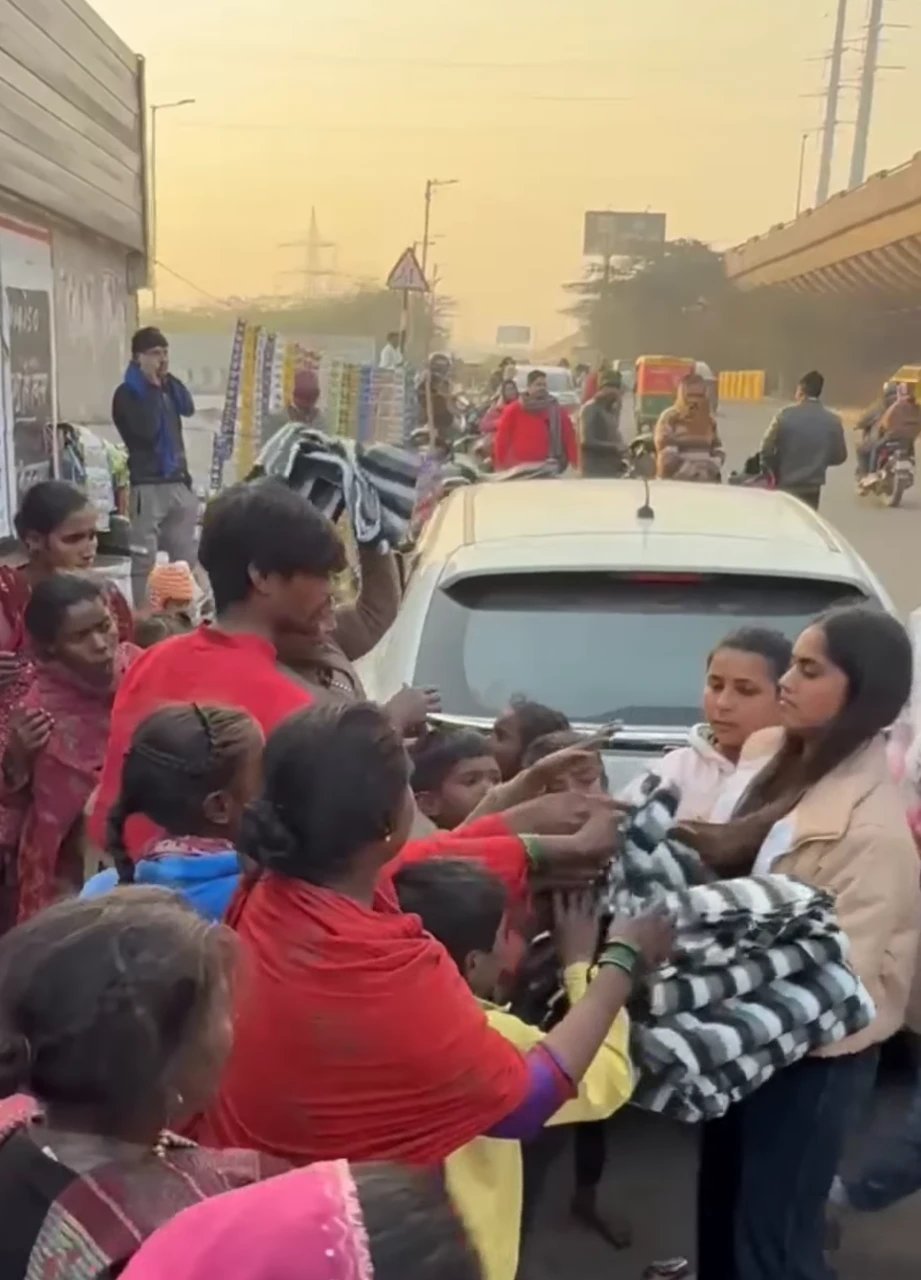 Our volunteers distributing blankets to families on the roadside in winter